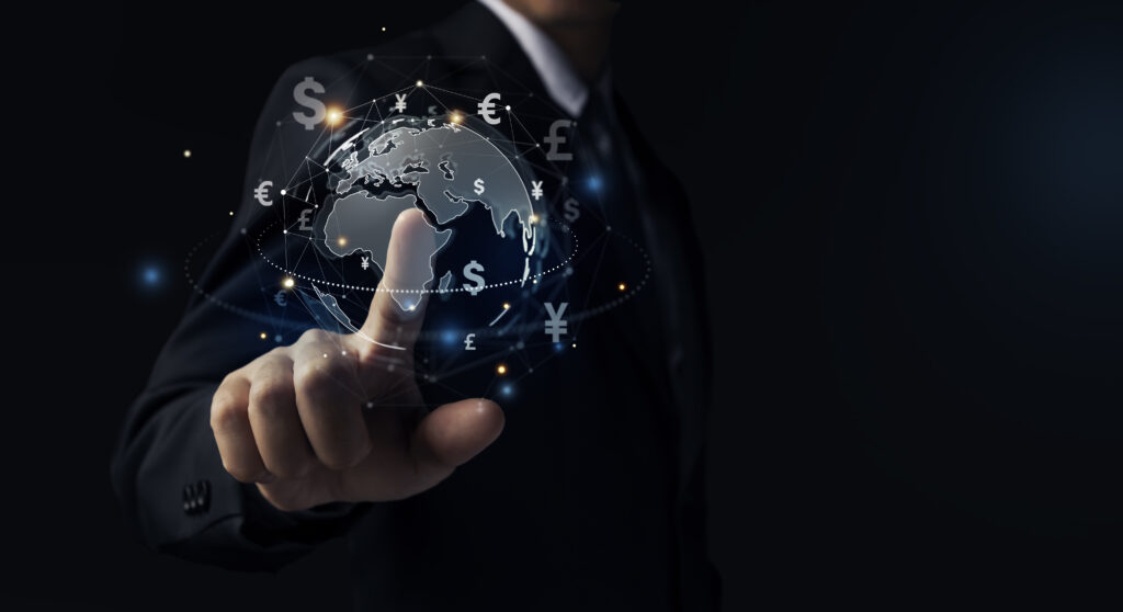 Hand touching globe and currency.
